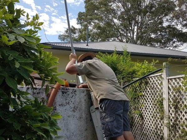 Staff cleaning a concrete tank