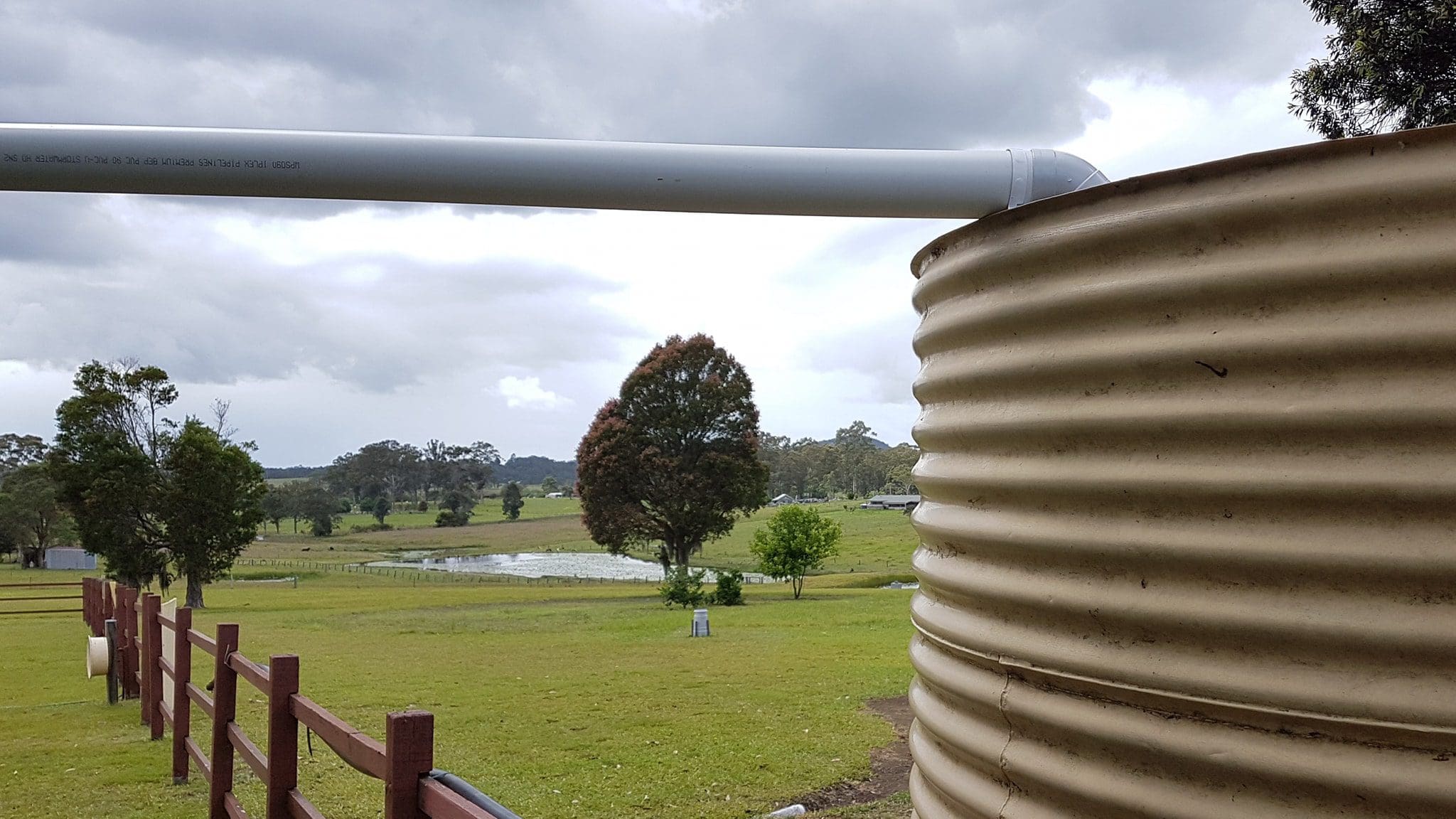 Galvanised water tank on farm land