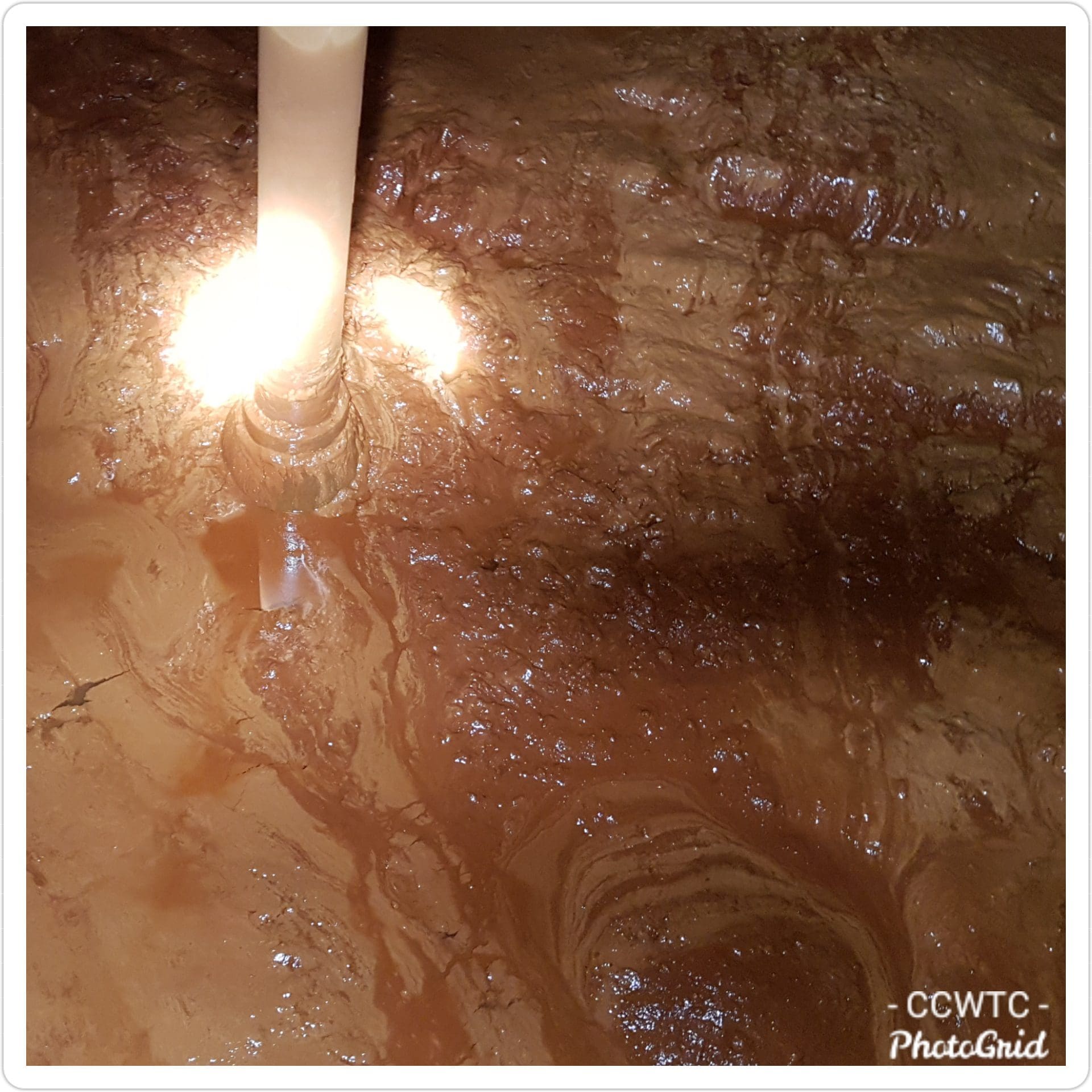 Inside a tank with deep sludge on the floor